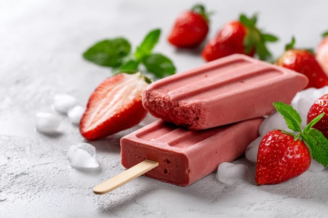 Homemade Strawberry Popsicles on White Background