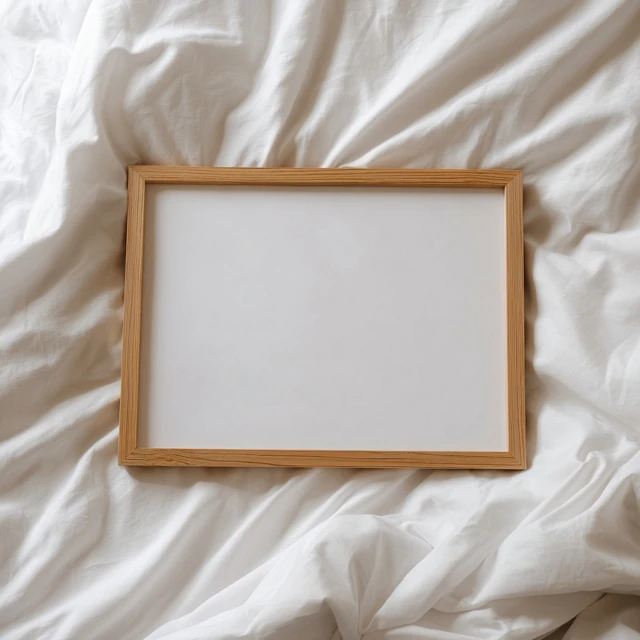 Wooden Picture Frame on White Bed Sheet