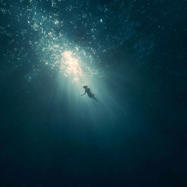 Woman Floating in Deep Ocean