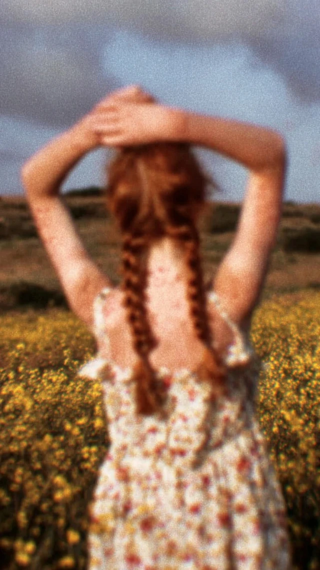 Red Haired Girl in Flower Field Freedom and Calm