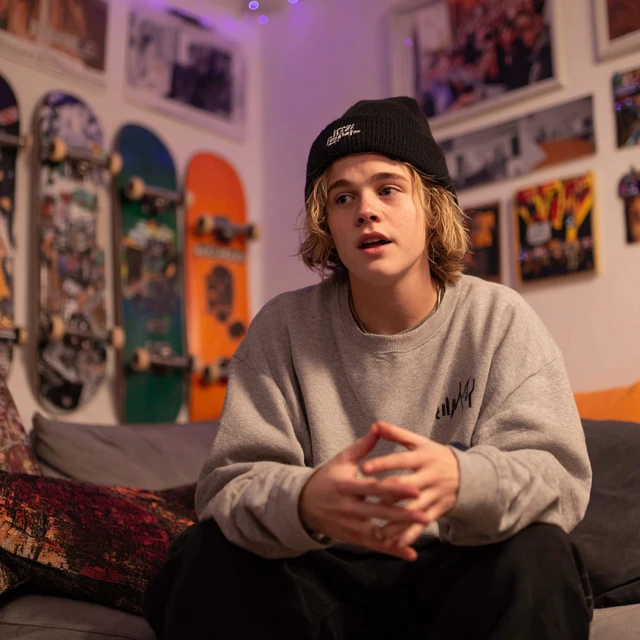 Confused Skater Boy At Home Talking On Phone