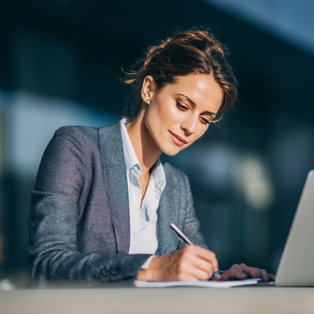 Businesswoman Writing Email Focused and Positive