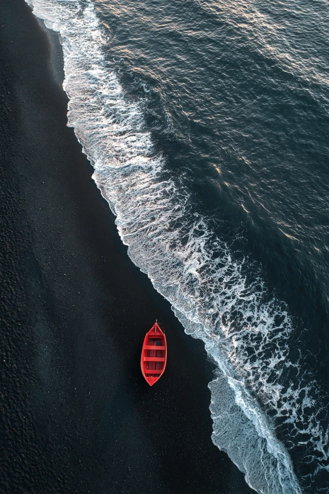 Red Boat on Black Sand Beach in Iceland