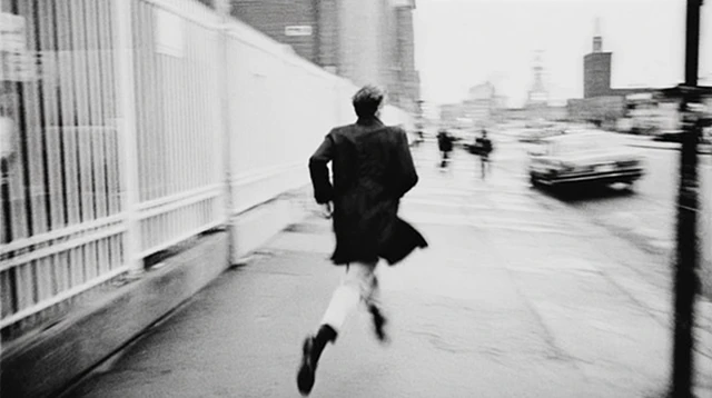 Man Running Down Street Black and White Photography