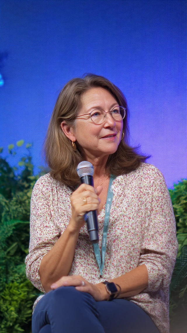 Woman Speaking on Stage at Conference