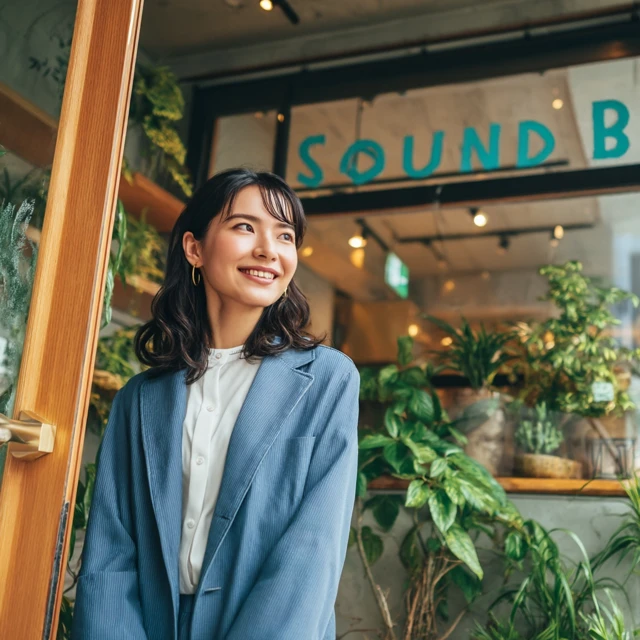 Japanese Woman Enters Sound Bar Cafe Smiling
