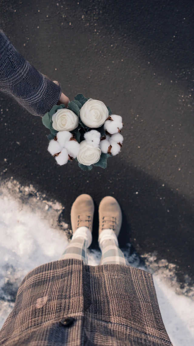 Winter Girl with Flowers in the Snow