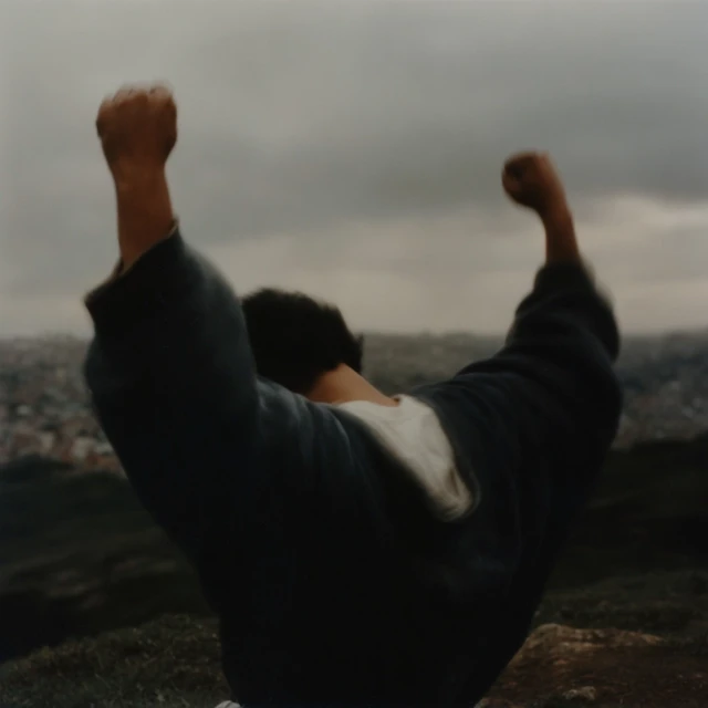 Hispanic Man Silhouetted Praying at Sunset