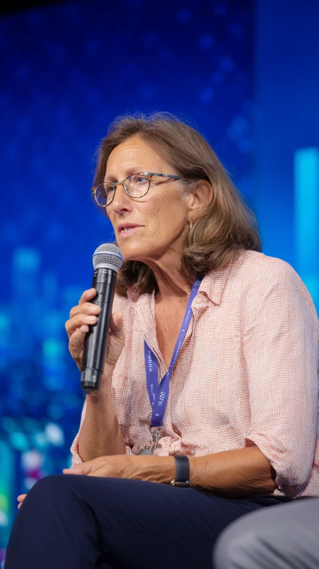 Woman Speaking on Stage at Conference