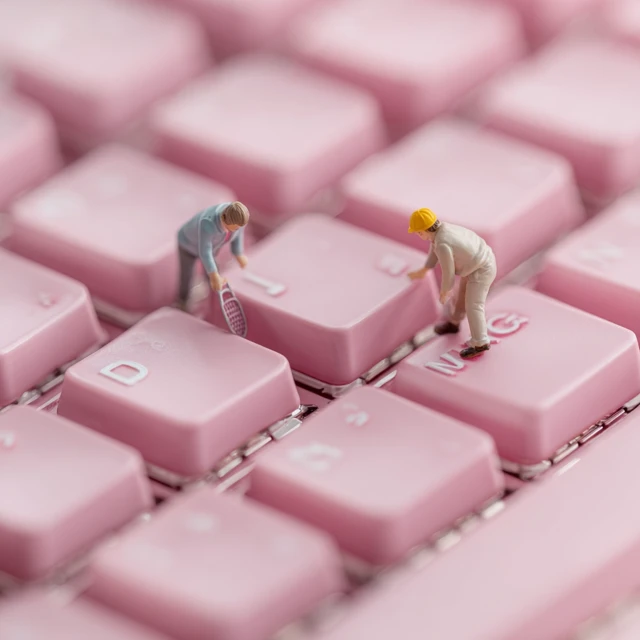Miniature People on a Pink Keyboard