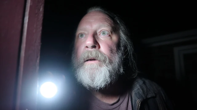 Man with Flashlight Investigating Cellar at Night