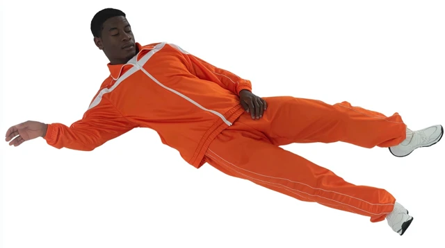 Man in Orange Sportswear Falling in Free Fall