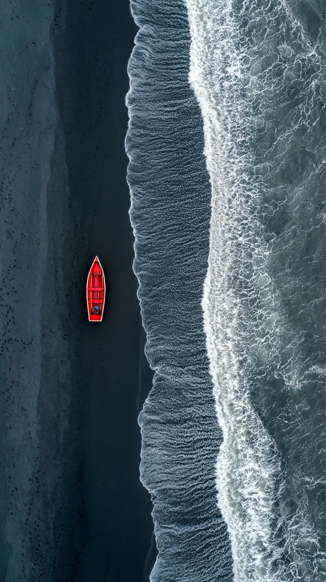 Red Boat on Black Sand Beach Iceland Aerial View