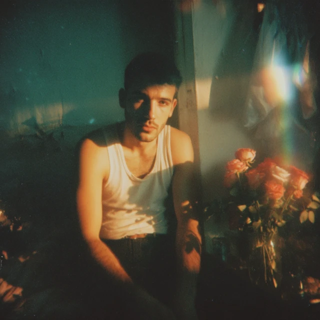 Man with Roses Blue Nighttime Photograph
