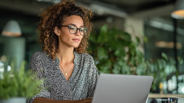 Businesswoman Working on Laptop in Modern Office