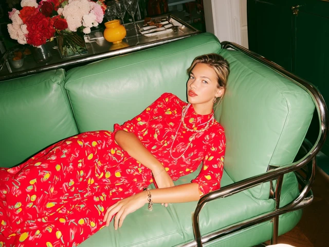 Woman in Floral Dress on Green Sofa