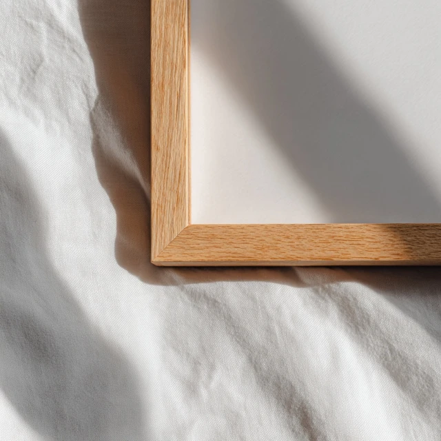 Wooden Picture Frame on White Bed Sheet