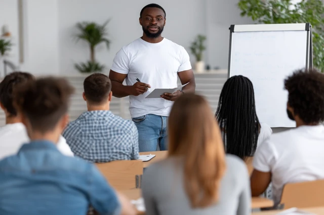 Teacher Explaining Lesson to Students Classroom