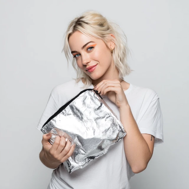 Smiling Woman with Makeup and Black Bag