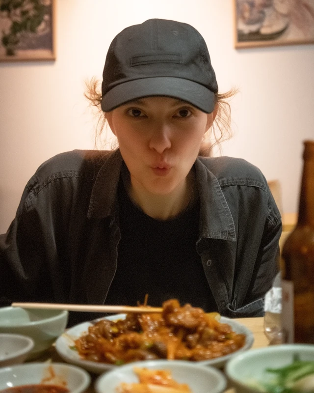 Young Woman Eating Korean Food Candid Photo