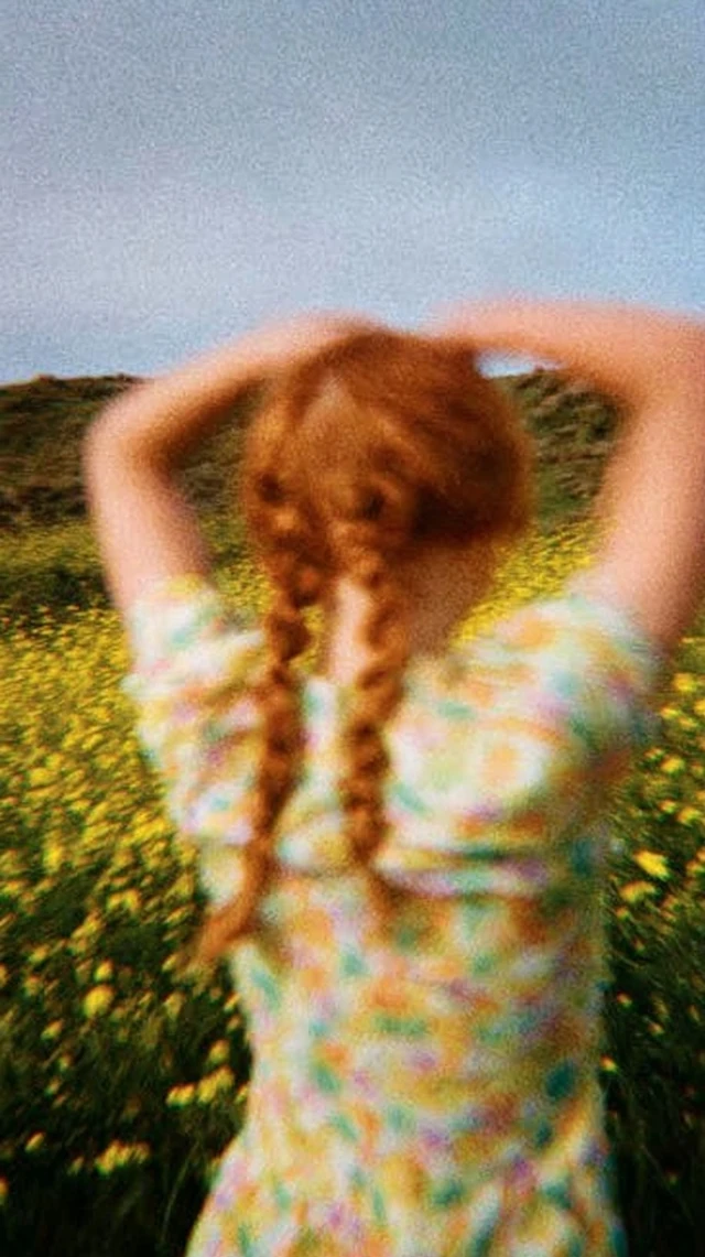 Red Haired Girl in Flower Field Freedom and Calm