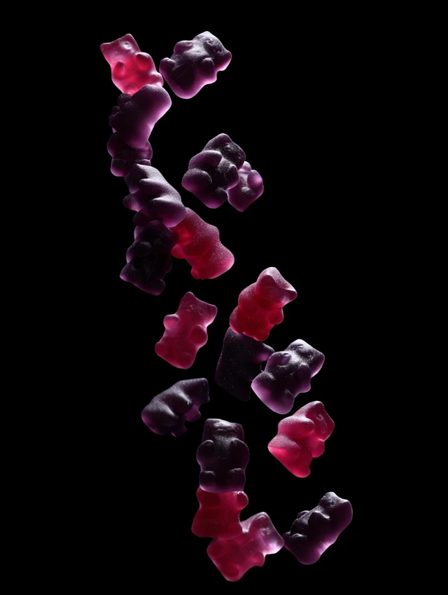 Gummy Bears Falling Down Red Purple Black Background
