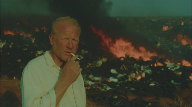 Middle Aged Man Smoking Amidst Flames