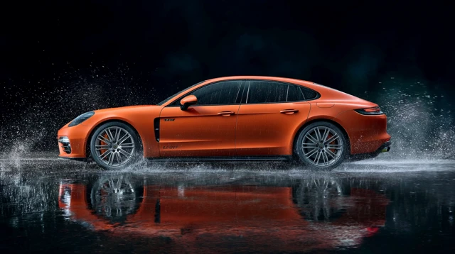 Orange Porsche Panamera Speeding in the Rain