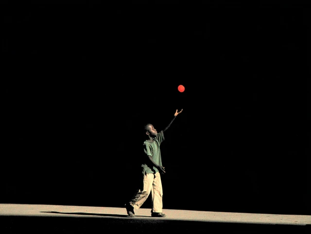 Candid Photo: Black Child Reaching for Red Ball