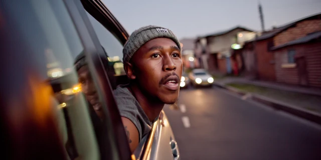 Young Man Leaning Out Car Window at Dusk South Africa
