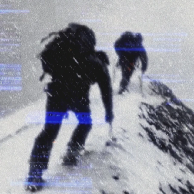 Mountain Climbers Summiting Snowy Peak
