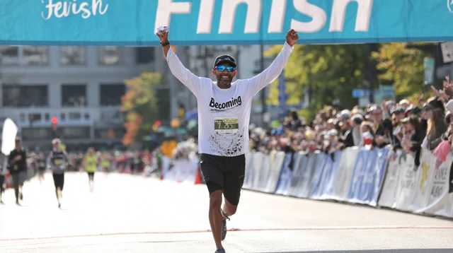 Runner Crossing Finish Line Triumphantly