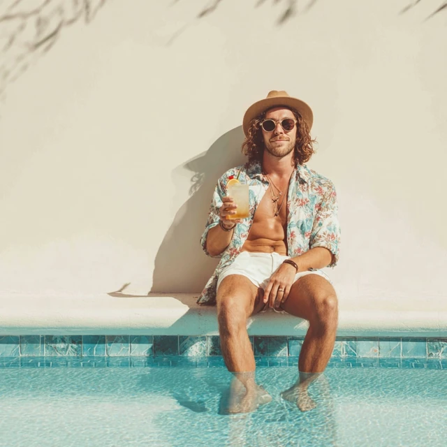 Man by Pool with Drink Relaxing Vacation