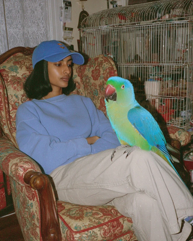 Woman in Cap with Parrot iPhone 14 Photo