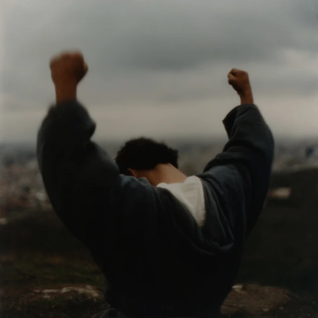 Hispanic Man Silhouetted Praying at Sunset