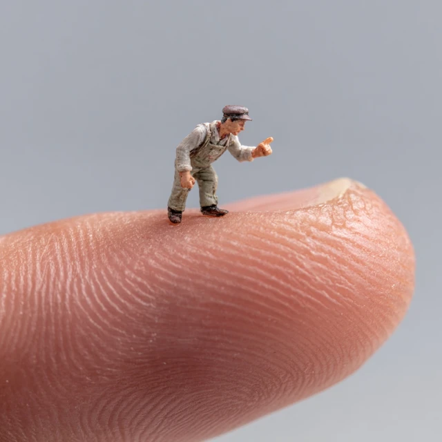 Miniature Action Hero Posing on a Finger