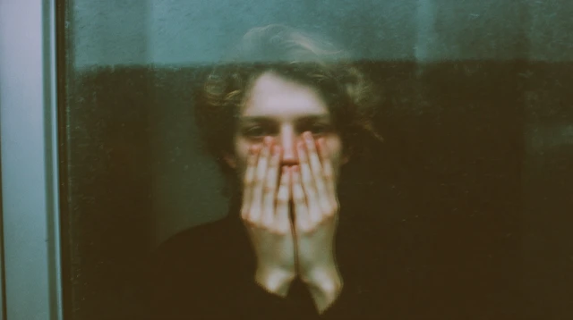 Person Presses Face Against Window