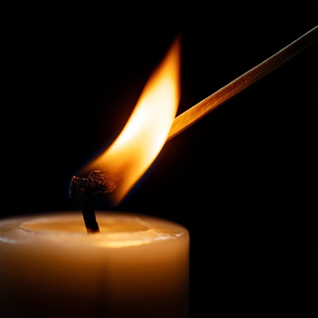 Candle Being Lit Closeup on Black Background